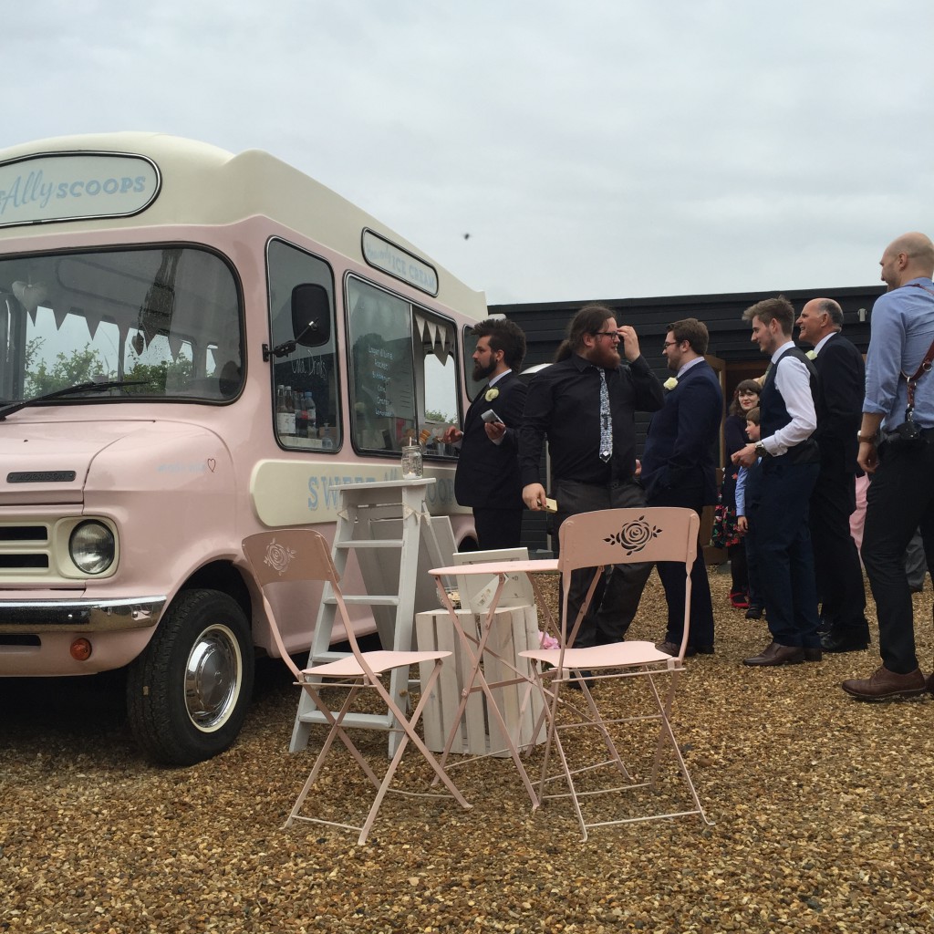 guests in line for ice cream from van